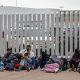 Migrantes esperan afuera de la garita internacional del Chaparral, el 10 de junio de 2023, en la ciudad fronteriza de Tijuana (México). EFE/Joebeth Terríquez