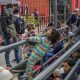Migrantes de diferentes nacionalidades, descansan en la entrada de la garita peatonal de San Ysidro para solicitar asilo a las autoridades estadounidenses, en Tijuana (México). EFE/Joebeth Terríquez