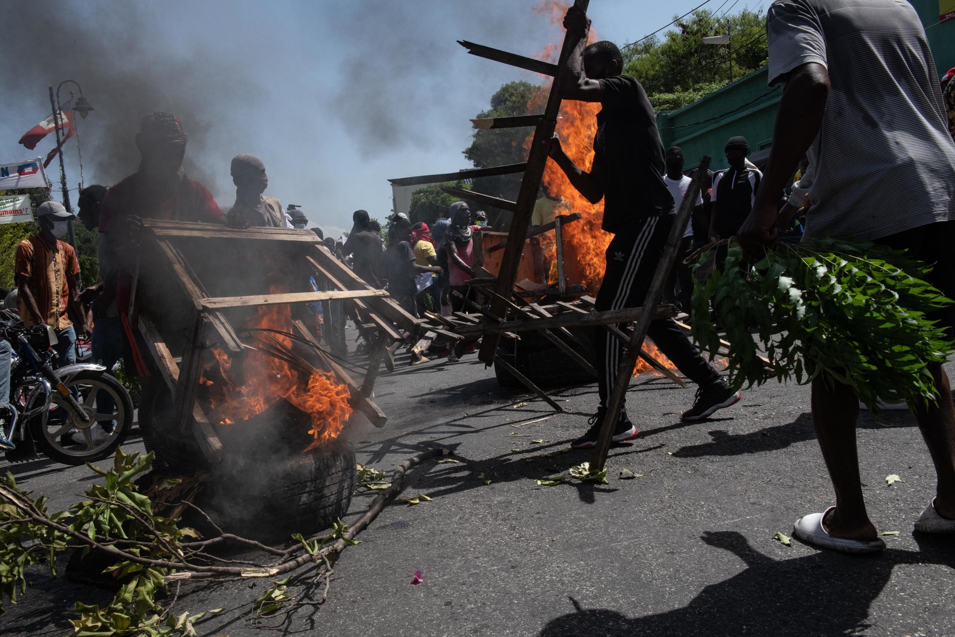 Manifestantes montan una barricada en llamas durante una marcha para exigir seguridad contra las pandillas en Puerto Príncipe (Haití). EFE/ Johnson Sabin