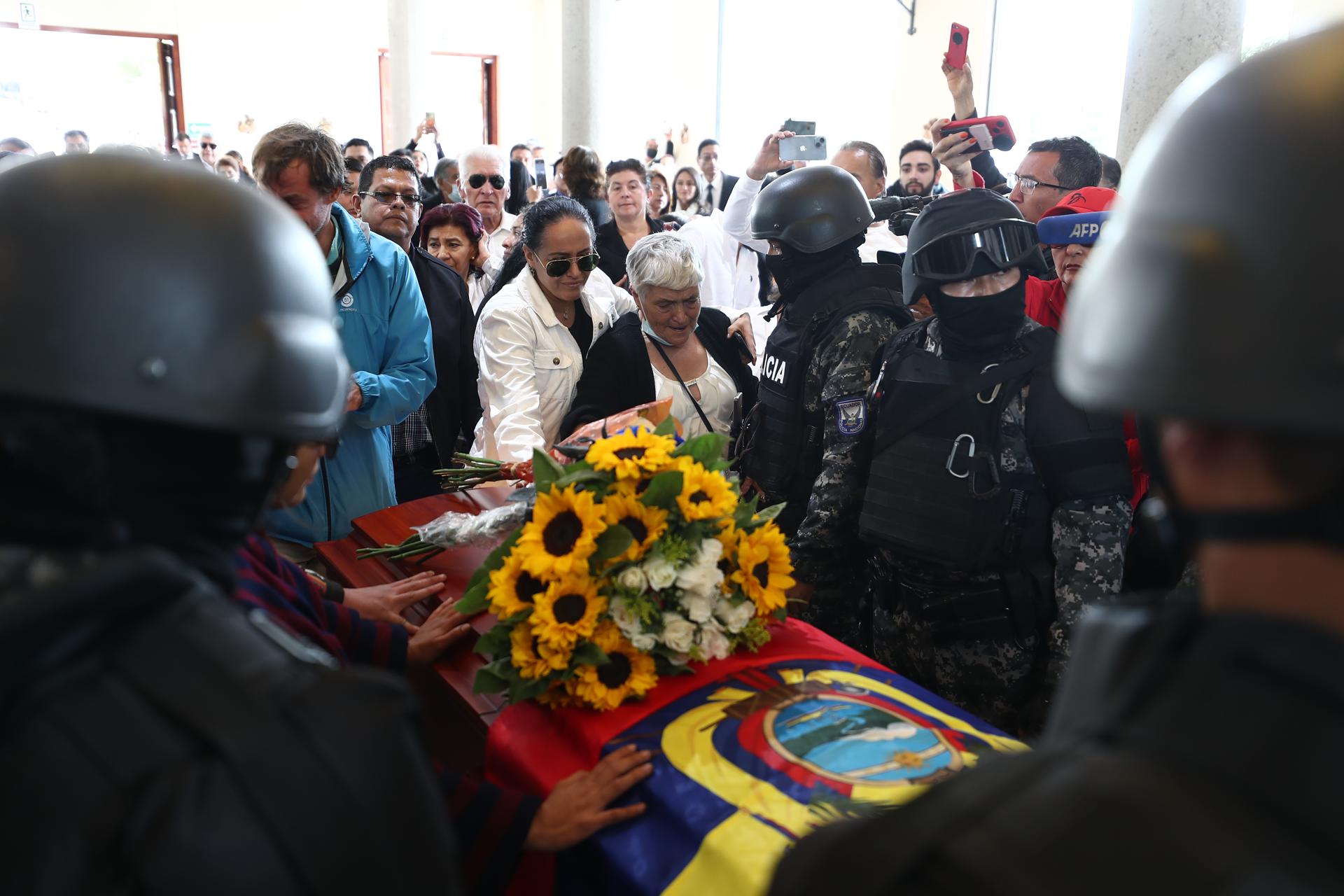 Glorica Valencia (c-d), madre del candidato presidencial Fernando Villavicencio, reacciona junto a su féretro, llevado por miembros de la Policía al cementerio hoy, en Quito (Ecuador). EFE/ José Jácome