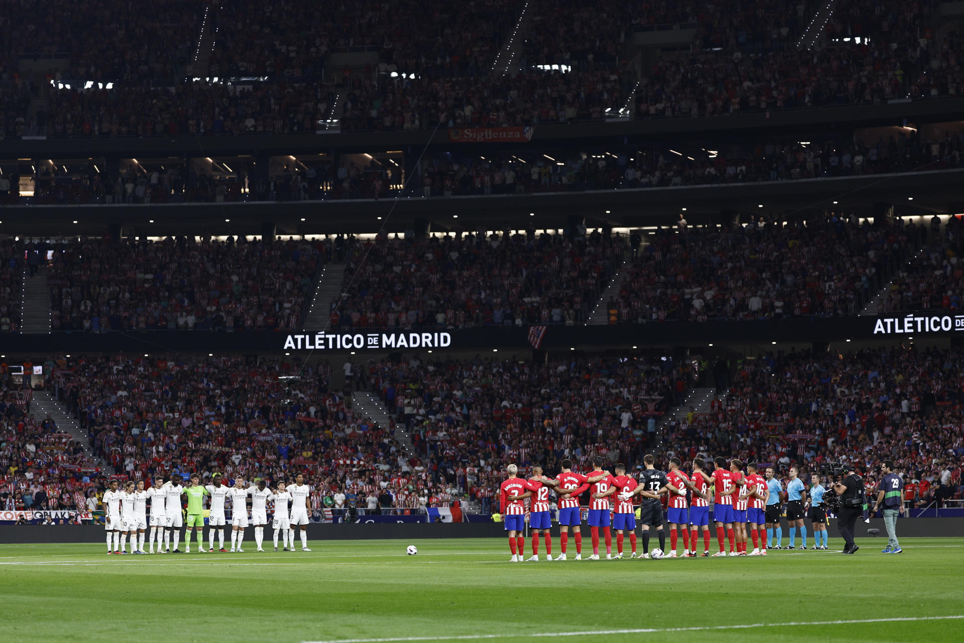 Las plantillas de Atlético de Madrid (d) y Real Madrid guardan un minuto de silencio al comienzo de la sexta de LaLiga. EFE/Rodrigo Jiménez/Archivo