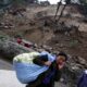Una mujer china fue registrada este jueves, 21 de diciembre, al cargar sus pertenencias cerca de una zona afectada por el terremoto de magnitud 6,2 que el pasado 18 de diciembre azoto el condado de Baoxin (China). EFE/Wu Hong