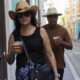 Una pareja camina con vasos de plástico durante las fiestas de la Calle San Sebastián en San Juan (Puerto Rico). EFE/ Thais Llorca