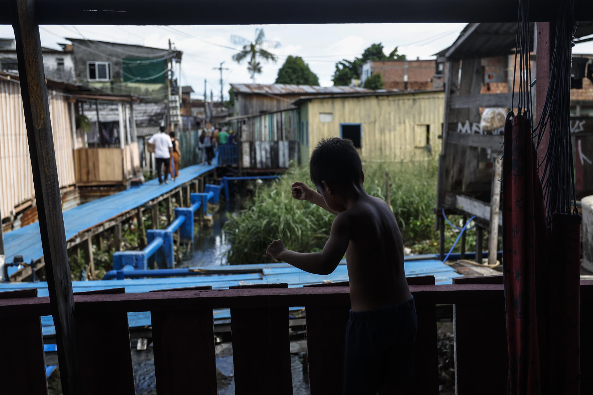Un niño juega junto a un sistema de alcantarillado el 11 de junio de 2024, en una zona de la ciudad de Manaos, capital del estado de Amazonas (Brasil). EFE/ Antonio Lacerda
