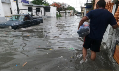 Un hombre y vehículo circulan por una calle inundada debido a las fuertes lluvias en Cancún, estado de Quintana Roo (México). EFE/ Alonso Cupul