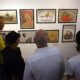 Visitantes observan una exposición de caricaturas durante la primera Bienal de Humor Político, este viernes en La Habana (Cuba). EFE/ Ernesto Mastrascusa