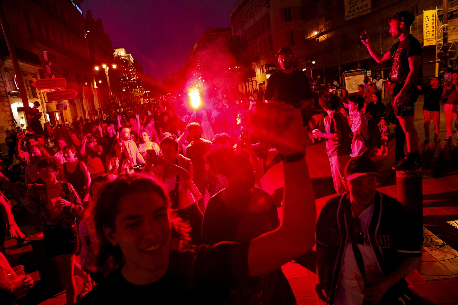 La gente reacciona tras el anuncio de los resultados de la segunda vuelta de las elecciones legislativas francesas, en Marsella, sur de Francia. EFE/EPA/TERESA SUAREZ