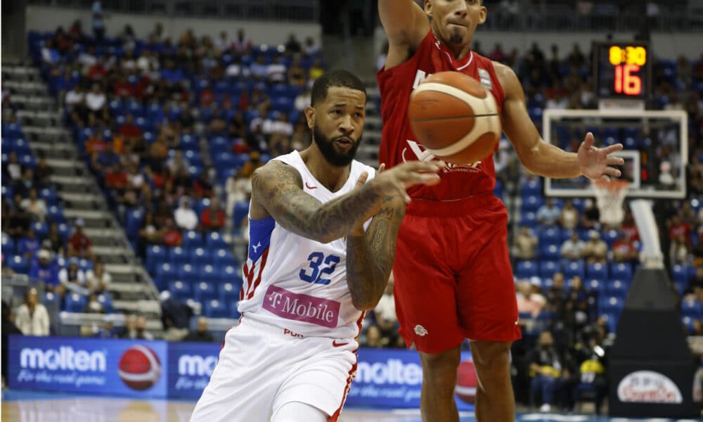 Christopher Ortiz (i) de Puerto Rico disputa el balón ante la defensa de Paul Stoll de México durante un juego de la semifinal del Torneo de Clasificación Olímpica FIBA. EFE/Thais Llorca