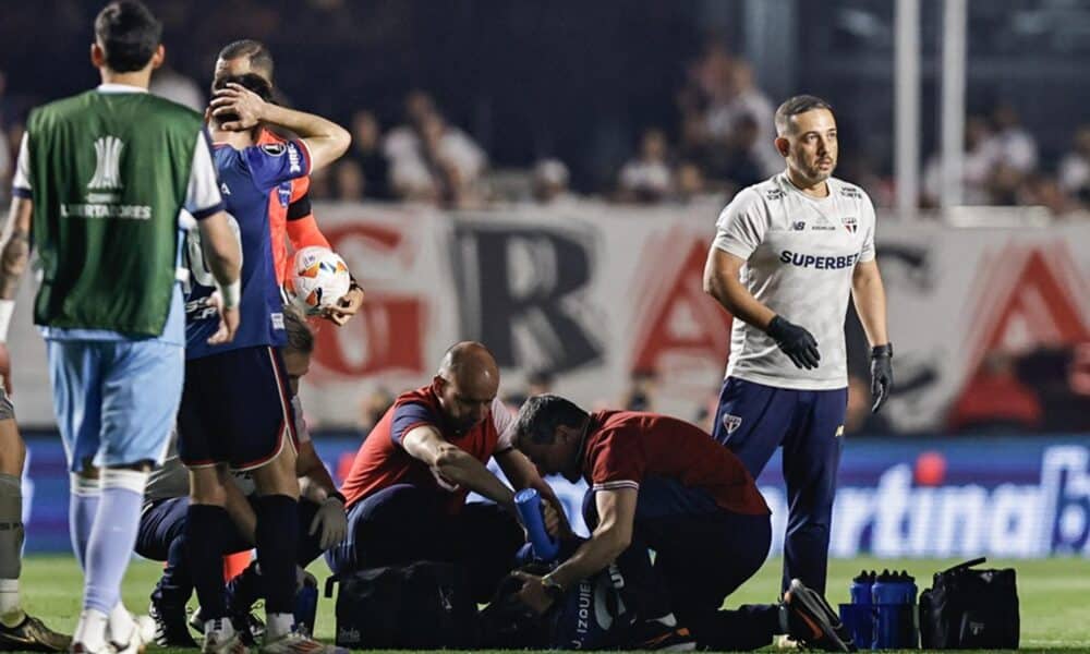 Juan Izquierdo (abajo) de Nacional es atendido por personal de la salud en el partido de vuelta de octavos de final de la Copa Libertadores entre Sao Paulo y Nacional. EFE/Isaac Fontana