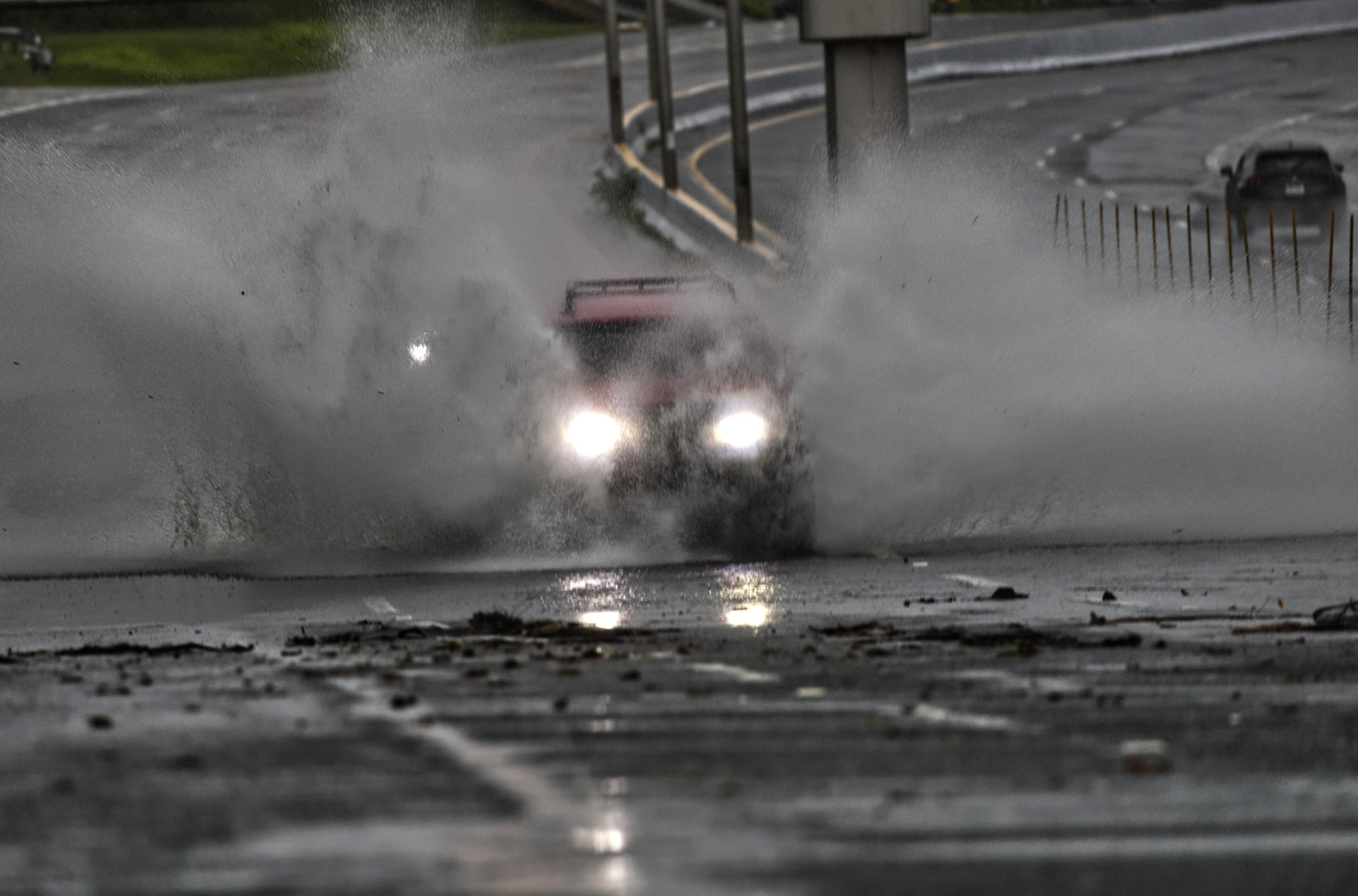 Un auto circula por una calle inundada por el paso del huracán Ernesto este miércoles, en San Juan, Puerto Rico. EFE/Thais Llorca