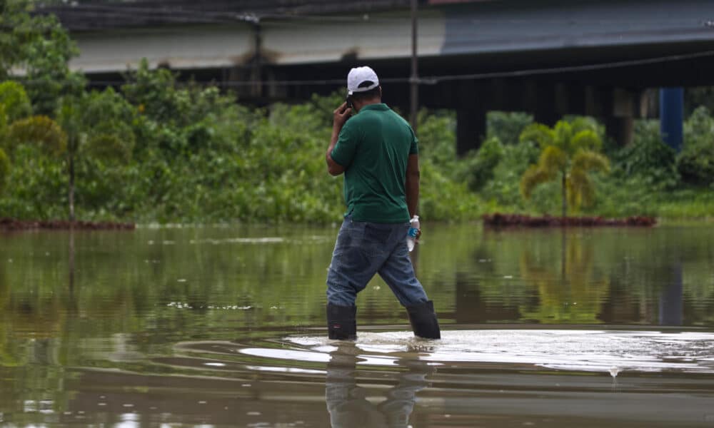 Un hombre camina a través de una carretera inundada tras el paso del huracán Ernesto, el miércoles en Dorado (Puerto Rico). EFE/ Thais Llorca