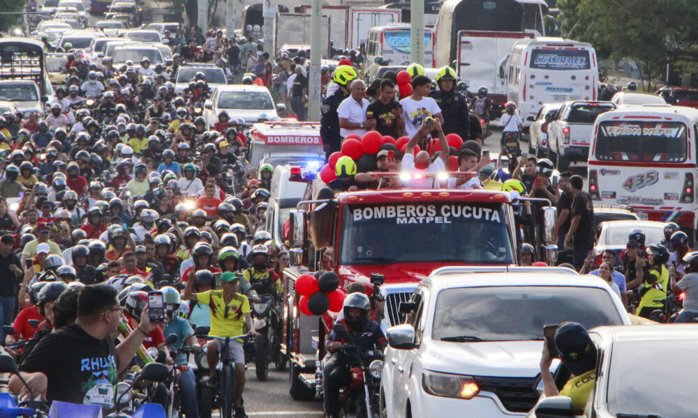 Cientos de personas fueron registradas este martes, 6 de agosto, al acompañar la caravana de recibimiento al gimnasta colombiano Ángel Barajas (arriba-d), luego de que ganara la medalla de plata en barra fija de los Juegos Olímpicos de París, en Cúcuta (Norte de Santander, Colombia). EFE/Mario Caicedo