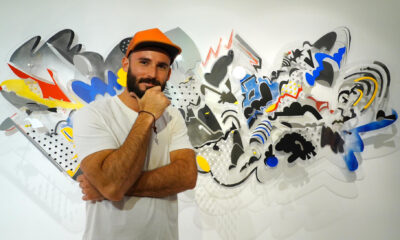 Fotografía del 19 de septiembre de 2024 del artista puertorriqueño, Edwin Maurás Maldonado, posando frente a una de sus obras durante su exposición en la galería A.Cueto, en San Juan (Puerto Rico). EFE/ Esther Alaejos