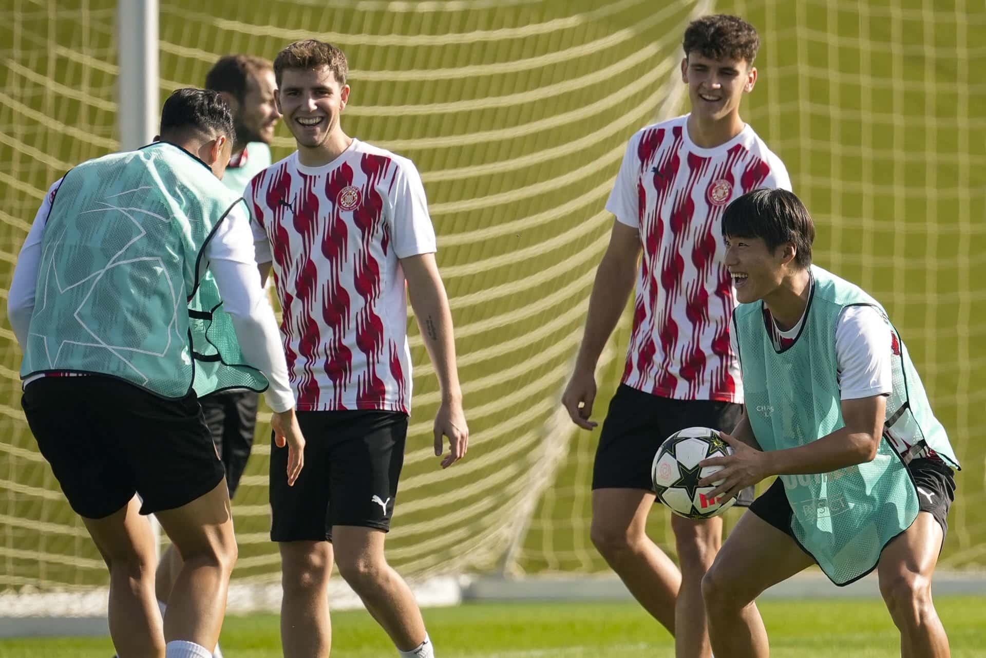 El jugador del Girona FC Min-Su Kim (d) durante el entrenamiento que su equipo ha realizado este lunes en la ciudad deportiva del club para preparar el partido de Liga de Campeones que mañana disputarán ante el Slovan Bratislava en el Estadio Municipal de Montilivi. EFE/David Borrat