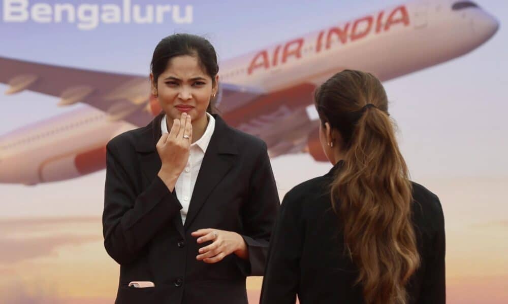 Bangalore (India), 04/09/2024.- Members of Air India stand in front of the Air India billboard during the groundbreaking ceremony for Air India Maintenance, Repair and Overhaul (MRO) facility at Bangalore International Airport Limited (BIAL) in Bangalore, India 04 September 2024. Air India Group announced on 04 September the commencement of construction of a mega Maintenance, Repair and Overhaul (MRO) facility reiterating its commitment to building a strong self-reliant aviation ecosystem. It will become an important hub for Air India group airlines' aircraft maintenance operations as the airline modernizes its fleet and expands its global operations. EFE/EPA/JAGADEESH NV