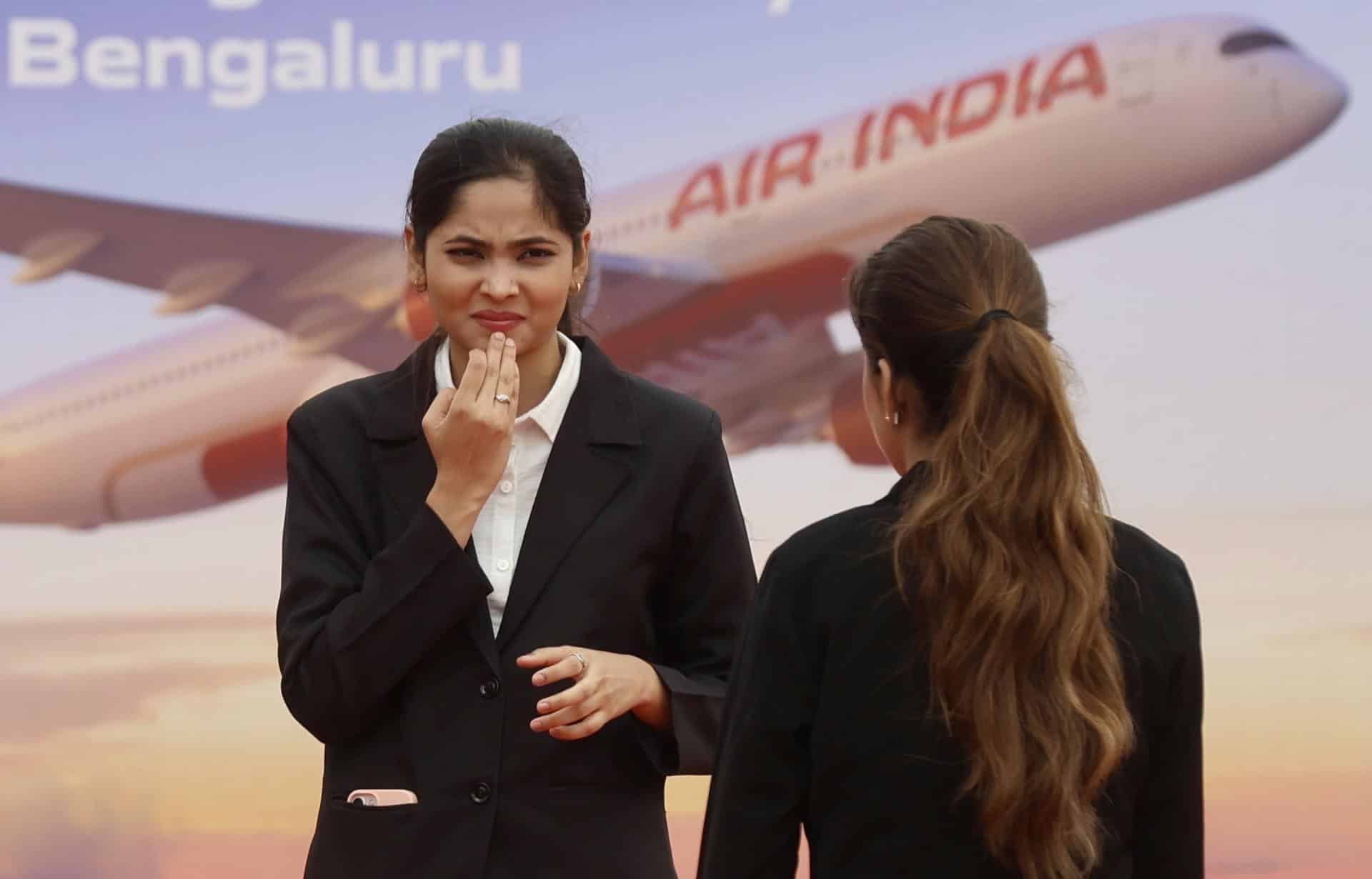 Bangalore (India), 04/09/2024.- Members of Air India stand in front of the Air India billboard during the groundbreaking ceremony for Air India Maintenance, Repair and Overhaul (MRO) facility at Bangalore International Airport Limited (BIAL) in Bangalore, India 04 September 2024. Air India Group announced on 04 September the commencement of construction of a mega Maintenance, Repair and Overhaul (MRO) facility reiterating its commitment to building a strong self-reliant aviation ecosystem. It will become an important hub for Air India group airlines' aircraft maintenance operations as the airline modernizes its fleet and expands its global operations. EFE/EPA/JAGADEESH NV