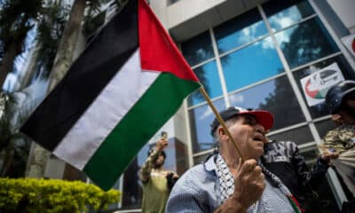 Un hombre sostiene una bandera palestina durante una manifestación en apoyo a Palestina, este jueves, en inmediaciones de la embajada del Reino Unido, en Caracas (Venezuela). EFE/ Miguel Gutierrez