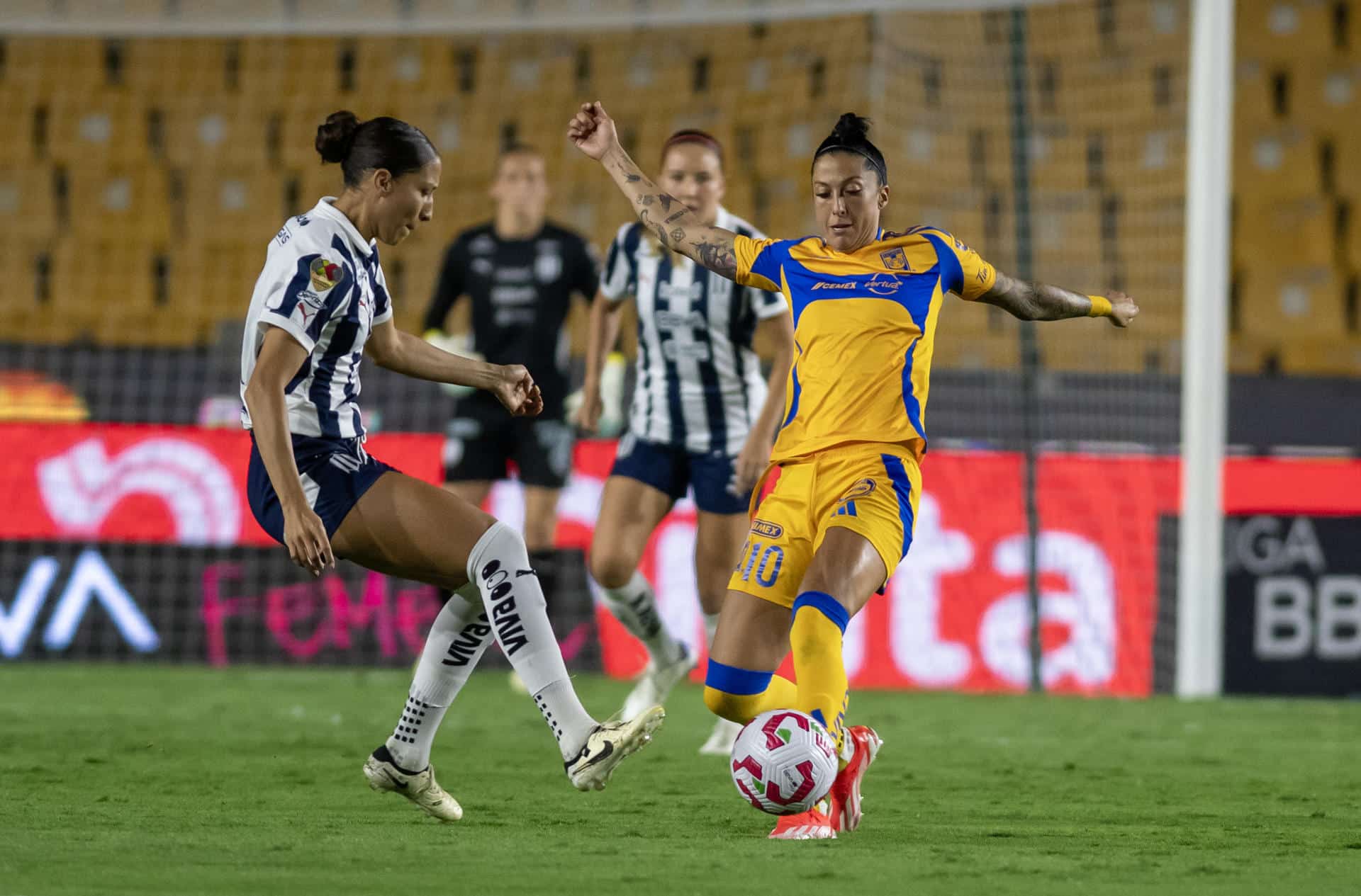 Jennifer Hermoso (d) de Tigres disputa un balón con Myra Delgadillo de Rayadas durante un partido de la Liga Femenil Mx en el estadio Universitario de la ciudad de Monterrey (México). Archivo.EFE/ Miguel Sierra