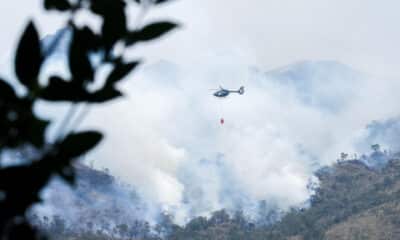 Fotografía cedida por el Cuerpo de Bomberos de Cuenca de un helicóptero combatiendo un incendio forestal en el Parque Nacional Cajas, en Cuenca (Ecuador). EFE/ Cuerpo de Bomberos de Cuenca