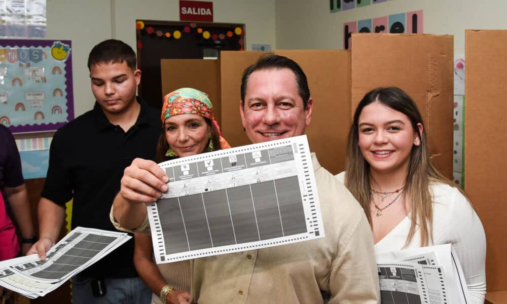 El candidato a la gobernación de Puerto Rico por la Alianza formada por el Partido Independentista Puertorriqueño (PIP) y el Movimiento Victoria Ciudadana (MVC), Juan Dalmau, muestra su papeleta de votación en compañía de su esposa (2i) y sus dos hijos, este martes en el Centro Cedin, en San Juan (Puerto Rico). EFE/Enid M. Salgado