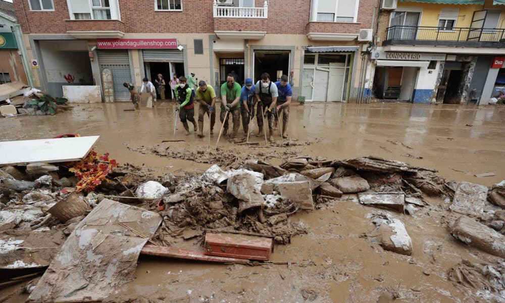 Vecinos de Paporta realizan labores de limpieza este lunes. EFE/ Manuel Bruque