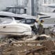 Dos bomberos inspeccionan las inmediaciones de una empresa con lanchas marinas en Massanassa, este miércoles. EFE/Miguel Ángel Polo