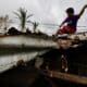 Santa Ana (Philippines), 14/11/2024.- A villager reinforces the roof of a damaged house caused by a recent typhoon in the coastal municipality of Santa Ana, Cagayan province, Philippines, 14 November 2024. After the onslaught of Typhoons Toraji, Trami, Yinxing and Kong-rey, the Philippines now brace for the landfall of Typhoon Usagi, the fifth major storm to hit the country in three weeks. Government officials warned residents of possible landslides due to ground saturation from successive typhoons impacting the Luzon island. (tormenta, deslizamiento de tierras, Filipinas) EFE/EPA/FRANCIS R. MALASIG