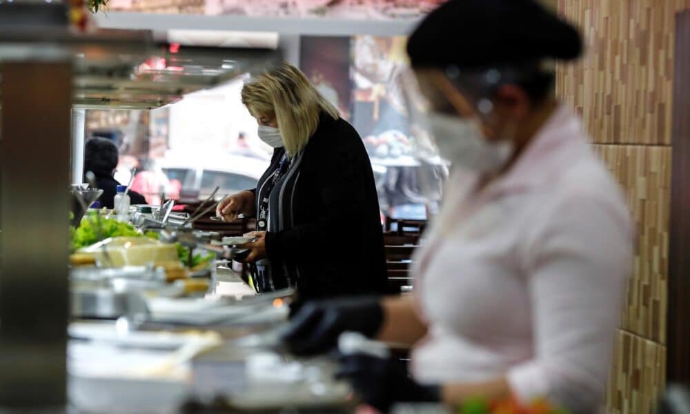 Fotografía de archivo en donde una mujer se sirve comida en un restaurante en Sao Paulo (Brasil). EFE/ Sebastiao Moreira