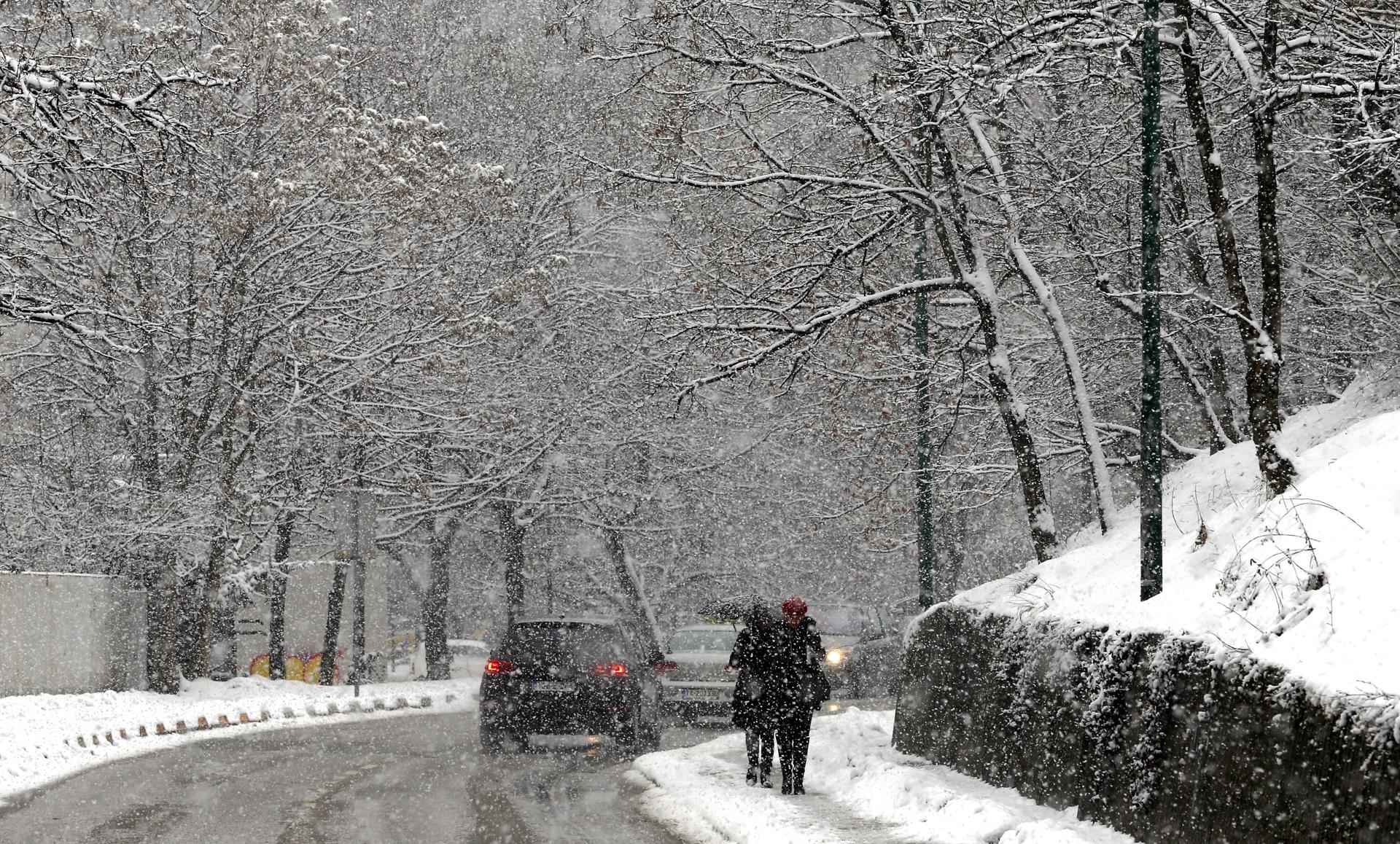 Varias personas caminan por una calle nevada en Sarajevo (Bosnia Herzegovina), en una imagen de archivo. EFE/ Fehim Demir