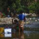 Fotografía de archivo en donde se ven dos mujeres que lavan ropa en un río contaminado con basura en la frontera entre Panamá y Colombia. EFE/ Bienvenido Velasco