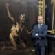 El director de la Galería de los Uffizi, Simone Verde, posa junto a la obra 'La Bruja', considerada la obra maestra de la pintura esotérica del siglo XVII, del artista maldito Salvator Rosa. EFE/ Galeria de los Uffizi