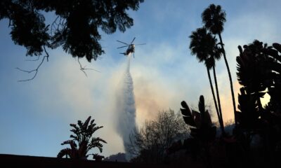 Un helicóptero lanza agua sobre el incendio forestal de Palisades, en Los Ángeles, California (EE.UU.). EFE/ALLISON DINNER