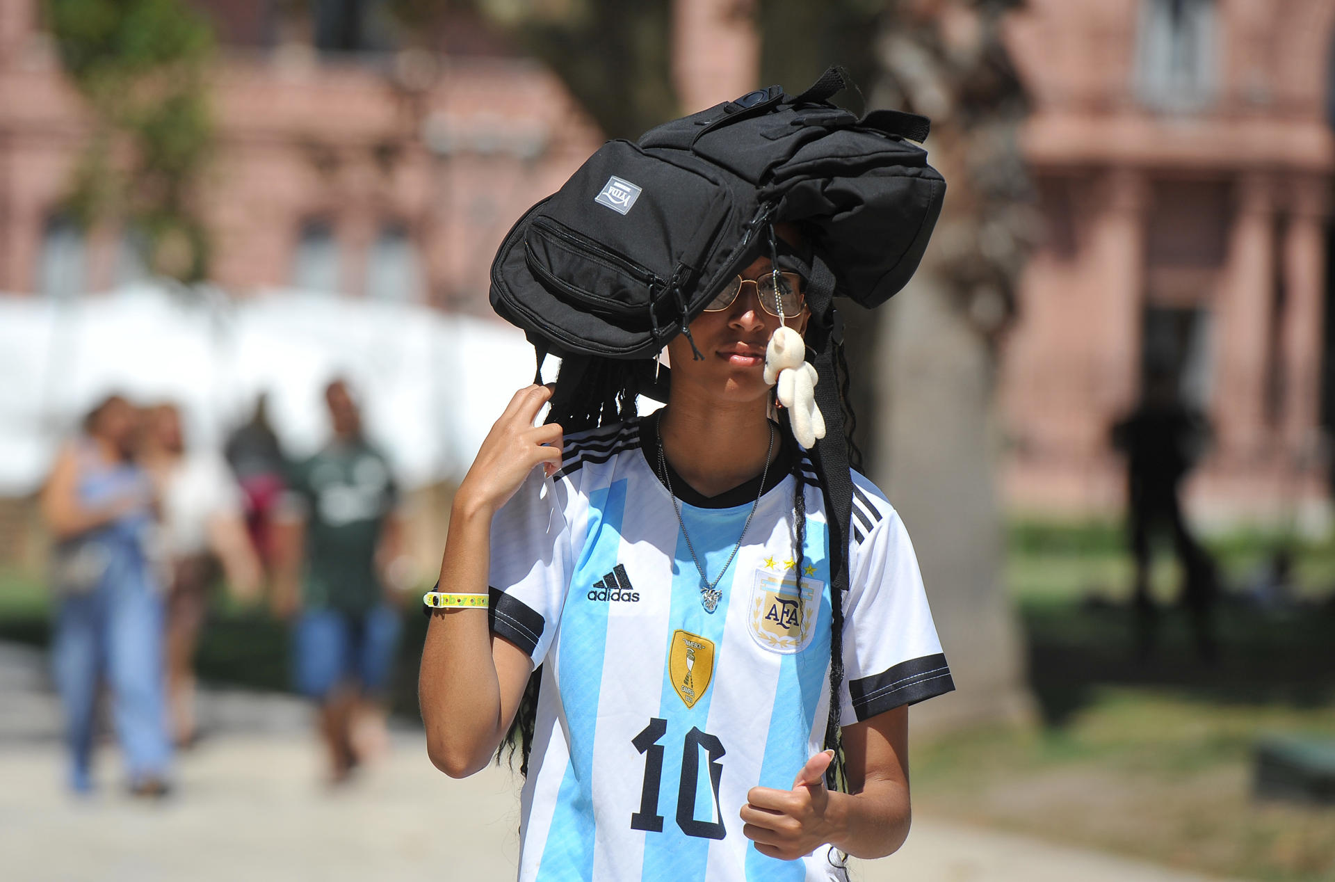 Fotografía de archivo de un hombre que cubre su cabeza por el sol mientras camina por Plaza de Mayo frente a Casa de Gobierno, durante la Ola de Calor que se presenta en Buenos Aires (Argentina). EFE/ Enrique Garcia Medina