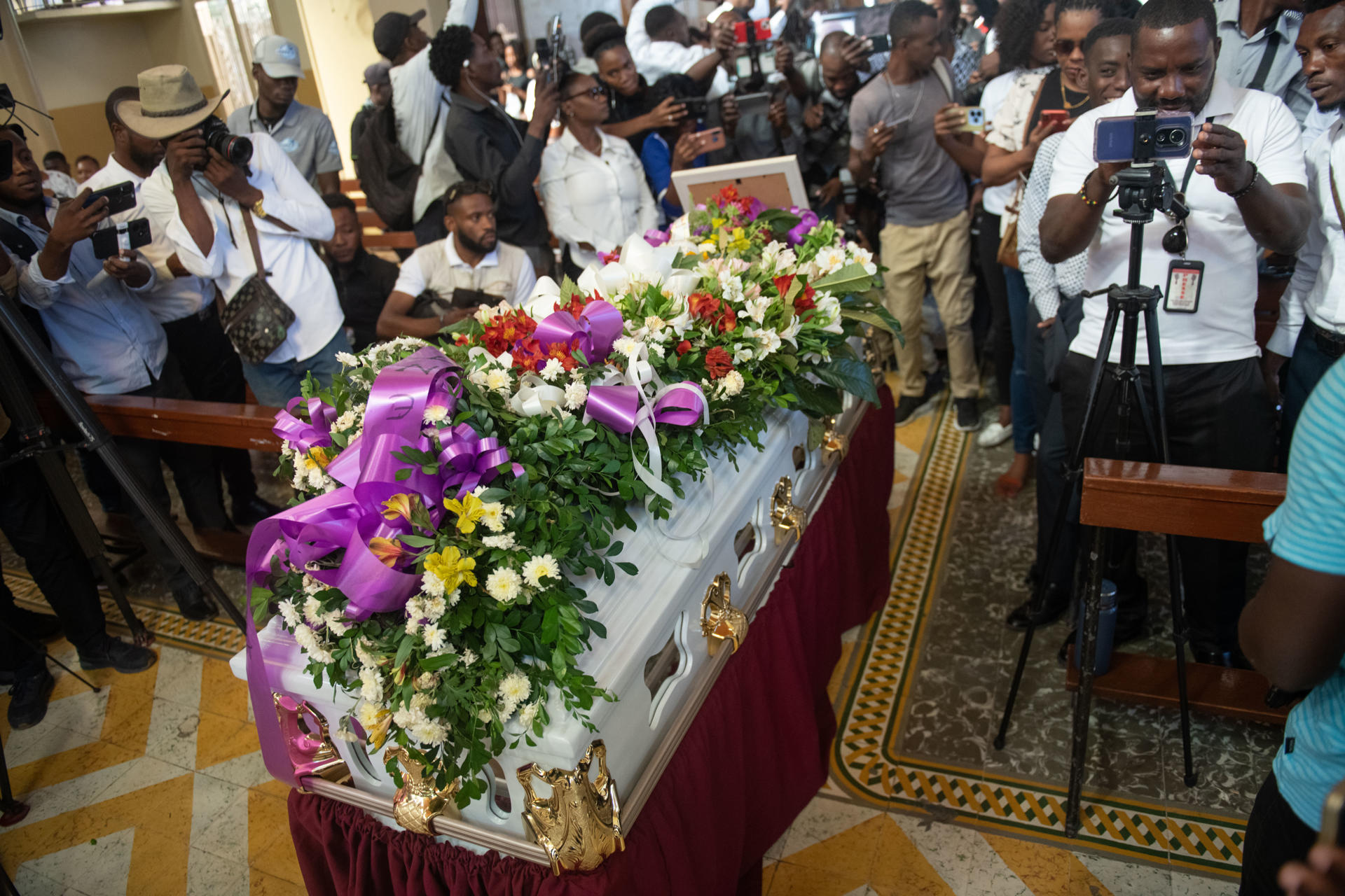 Personas asisten a una ceremonia fúnebre de Jimmy Jean, periodista asesinado por bandas armadas el 24 de diciembre de 2024, en la iglesia Saint Pierre este jueves, en Petion-ville (Haití). EFE/ Johnson Sabin