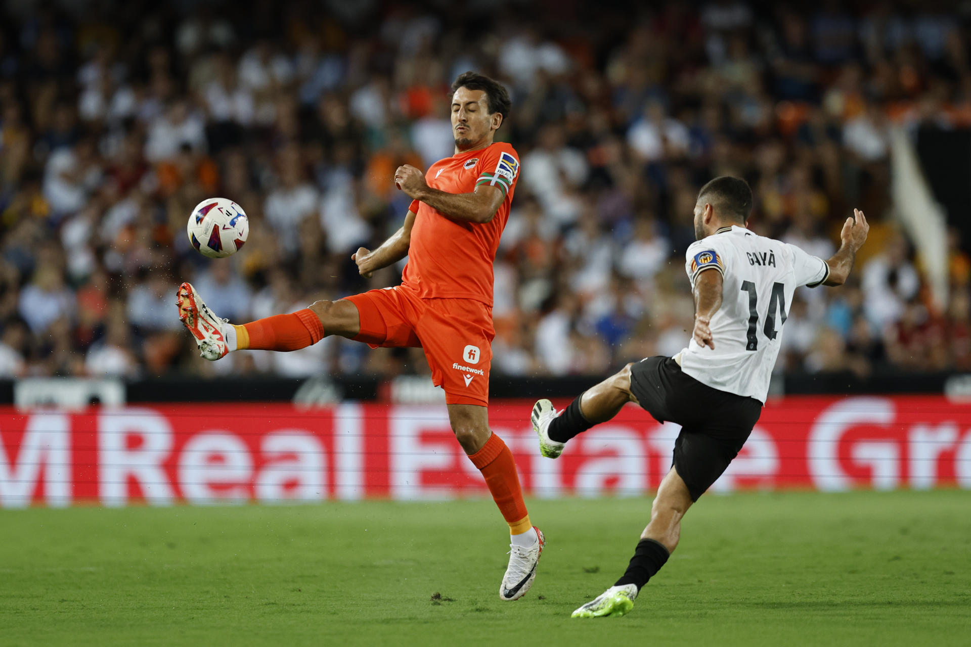 El defensa del Valencia José Luis Gayá (d) despeja el balón ante la presión de Mikel Oyarzabal (i), en el estadio de Mestalla en Valencia en foto de archivo de Biel Aliño. EFE