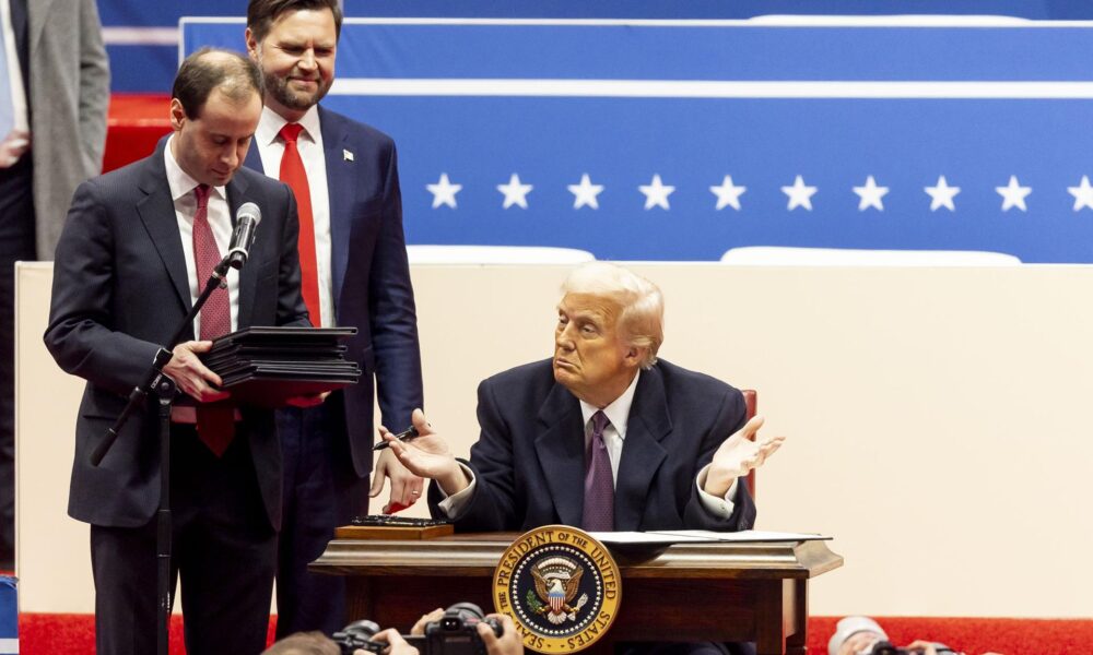 El presidente de Estados Unidos, Donald Trump (c), junto al vicepresidente estadounidense, J.D. Vance (segundo a la izquierda), mientras firma una serie de decretos en el escenario durante un acto inaugural presidencial en el Capitol One Arena en Washington, DC (EE.UU.). EFE/ALLISON DINNER