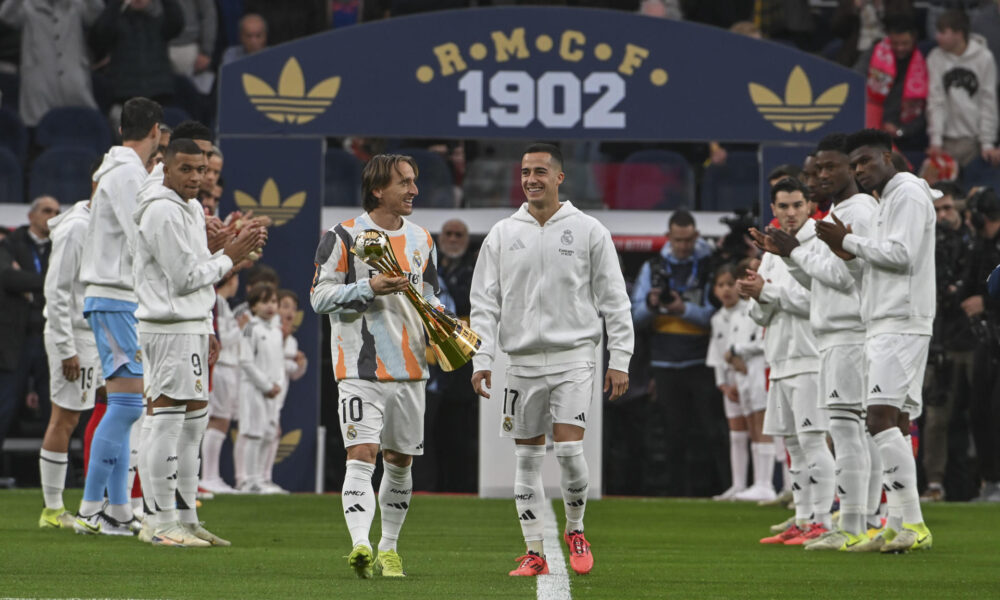 Los jugadores del Real Madrid Luka Modric (c-i) y Lucas Vázquez (c-d) muestran al público el Trofeo de la Copa Intercontinental,en el estadio Santiago Bernabéu en foto de archivo de Fernando Villar. EFE