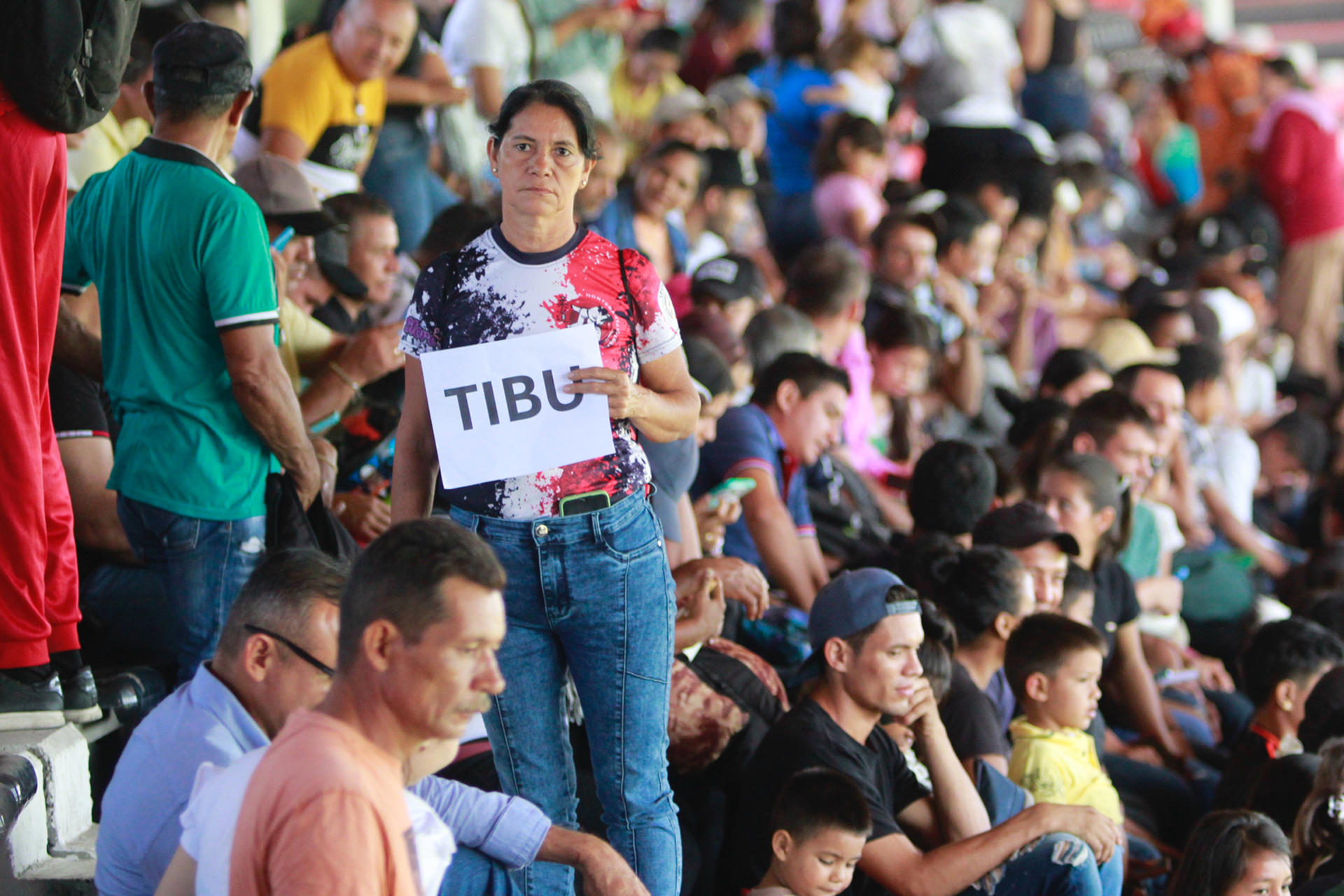 Una mujer desplazada por la violencia sostiene un cartel en el estadio General Santander este 19 de enero de 2025, en Cúcuta (Colombia). EFE/ Mario Caicedo