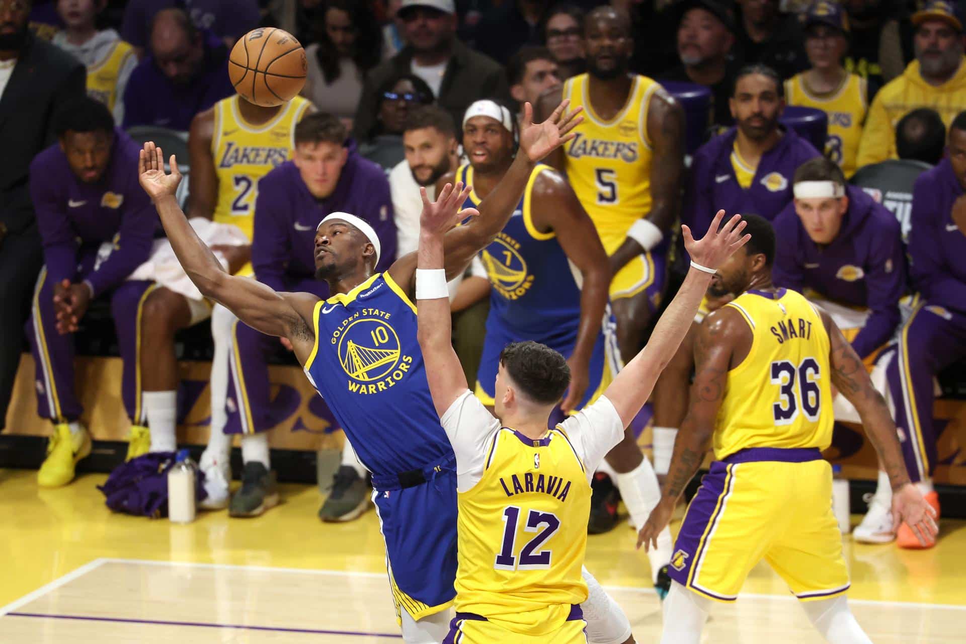El alero de Golden State Warriors Jimmy Butler (i) lanza el balón ante la oposición de Deandre Ayton (d). EFE/EPA/ALLISON DINNER SHUTTERSTOCK OUT