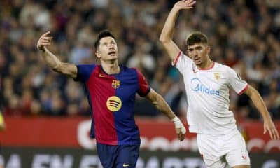 El delantero del FC Barcelona Robert Lewandowski (i) junto al sevillista Kike Salas, durante el encuentro de la jornada 23 de la pasada LaLiga EA Sports disputado en el Sánchez Pizjuán. EFE/ Julio Muñoz