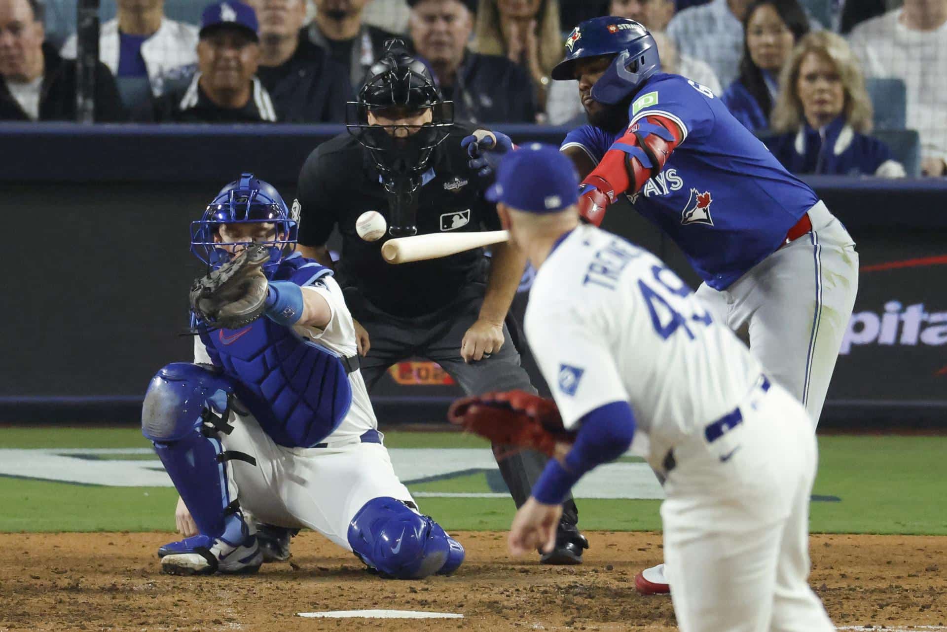 El primera base de los Azulejos de Toronto Vladimir Guerrero Jr. (d), conecta un sencillo contra el lanzador de los Los Angeles Dodgers, Blake Treinen (2-i), durante la séptima entrada del juego tres de la Serie Mundial de MLB. EFE/EPA/CAROLINE BREHMAN