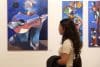 Una persona observa la exposición 'Destellos de Luz' del pintor ecuatoriano Olmedo Quimbita este jueves, en Lima (Perú). EFE/ Paolo Aguilar