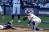 LOS ANGELES (United States), 17/10/2025.- Milwaukee Brewers third baseman Caleb Durbin (L) slides in safe with a triple against Los Angeles Dodgers third baseman Max Muncy (R) during the second inning of the MLB National League Championship Series game three between the Milwaukee Brewers and the Los Angeles Dodgers in Los Angeles, California, USA, 16 October 2025. The winner of the best-of-seven games National League Championship Series will advance to the World Series to play the winner of the American League Championship Series. EFE/EPA/ALLISON DINNER