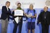 El colombiano Jairo Forero y su hijo Nicolás reciben el certificado del peregrino 500.000 del Camino de Santiago en la ciudad de Santiago de Composterla . EFE/Lavandeira jr.