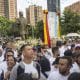 Personas participan en una marcha para celebrar la canonización de los primeros dos santos venezolanos, el médico José Gregorio Hernández y la religiosa Carmen Rendiles este miércoles, en Caracas (Venezuela). EFE/ Miguel Gutiérrez