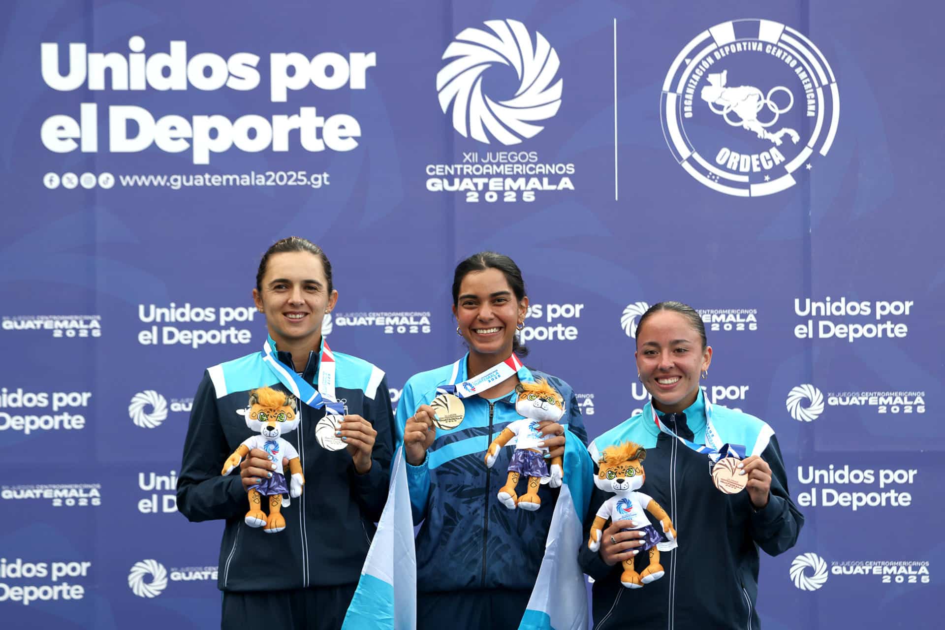 La hondureña Natalie Espinal (c), con la medalla de oro del tenis individual femenino, posa junto a Andrea Weendon, de Guatemala, quien ganó la plata; y Deborah Domínguez, también de Guatemala, que se quedó con el bronce en los Juegos Centroamericanos en Ciudad de Guatemala. EFE/Mariano Macz