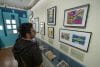 Fotografía del 10 de octubre de 2025 de una persona recorriendo la exposición "¡Wepa! Puertorriqueños en el mundo de los comics!", en la Biblioteca Publica de Nueva York (EE.UU.). . EFE/ Angel Colmenares
