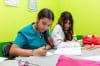 Fotografía del 27 de septiembre de 2025, que muestra a dos niñas escribiendo en sus cuadernos durante una clase del Grupo de Apoyo a Migrantes de La Romaine (Larms), en San Fernando (Trinidad y Tobago). EFE/ Andrea De Silva