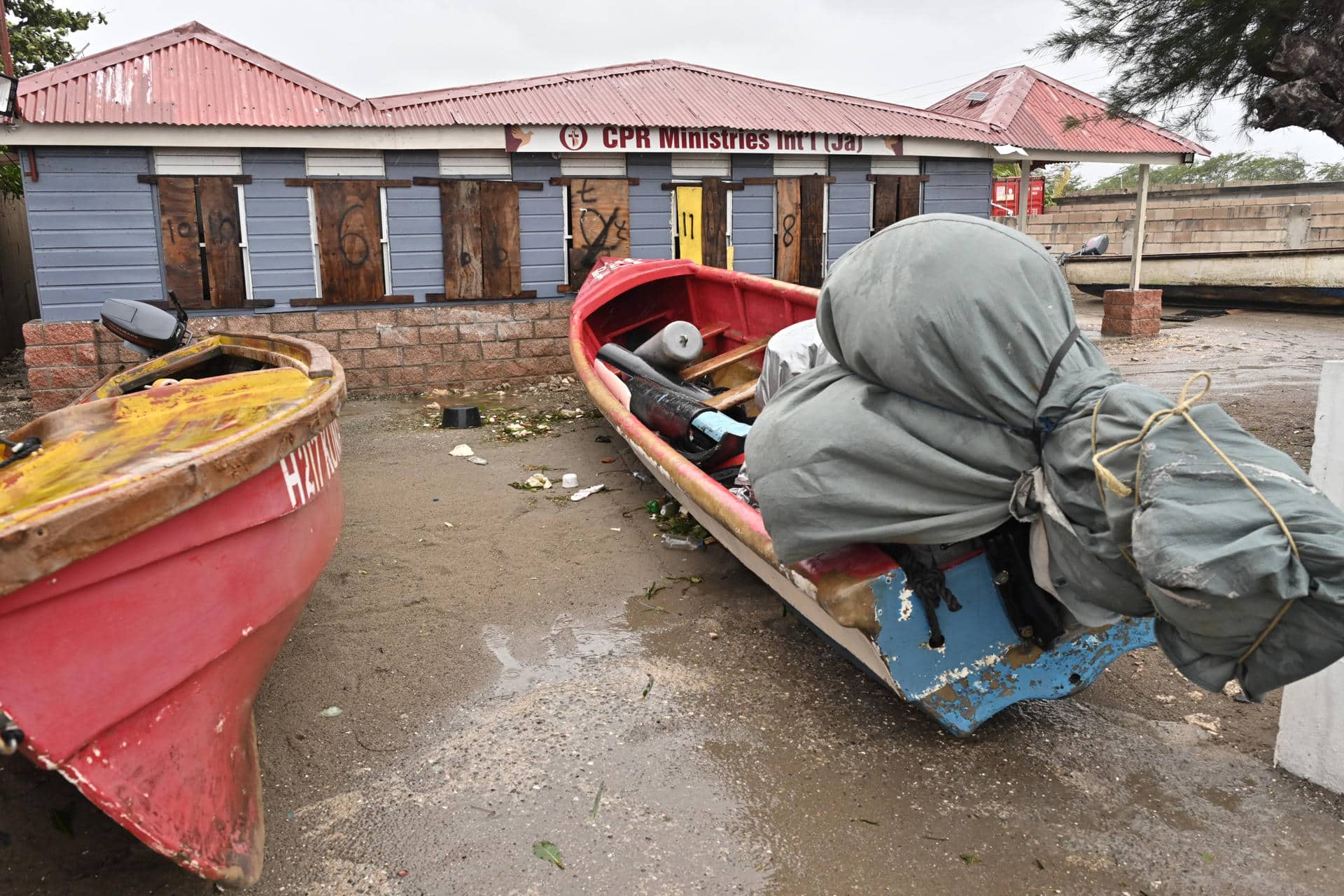 Fotografía de un barco cubierto en tierra ante el inminente paso del huracán Melissa ayer lunes, en la playa pesquera de Port Henderson (Jamaica). EFE/Rudolph Brown
