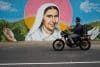 Fotografía del 06 de octubre de 2025 de una persona transitando frente a un mural de la Madre Carmen Rendiles, en Caracas (Venezuela). EFE/ Ronald Peña R